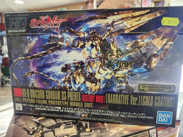 Photographie de la boîte de maquette Bandai Namco High Grade (HG) représentant le mobile suit doré RX-0 Unicorn Gundam 03 Phenex en mode Destroy (version Narrative avec revêtement doré), affichant un prix de 59,90 €.