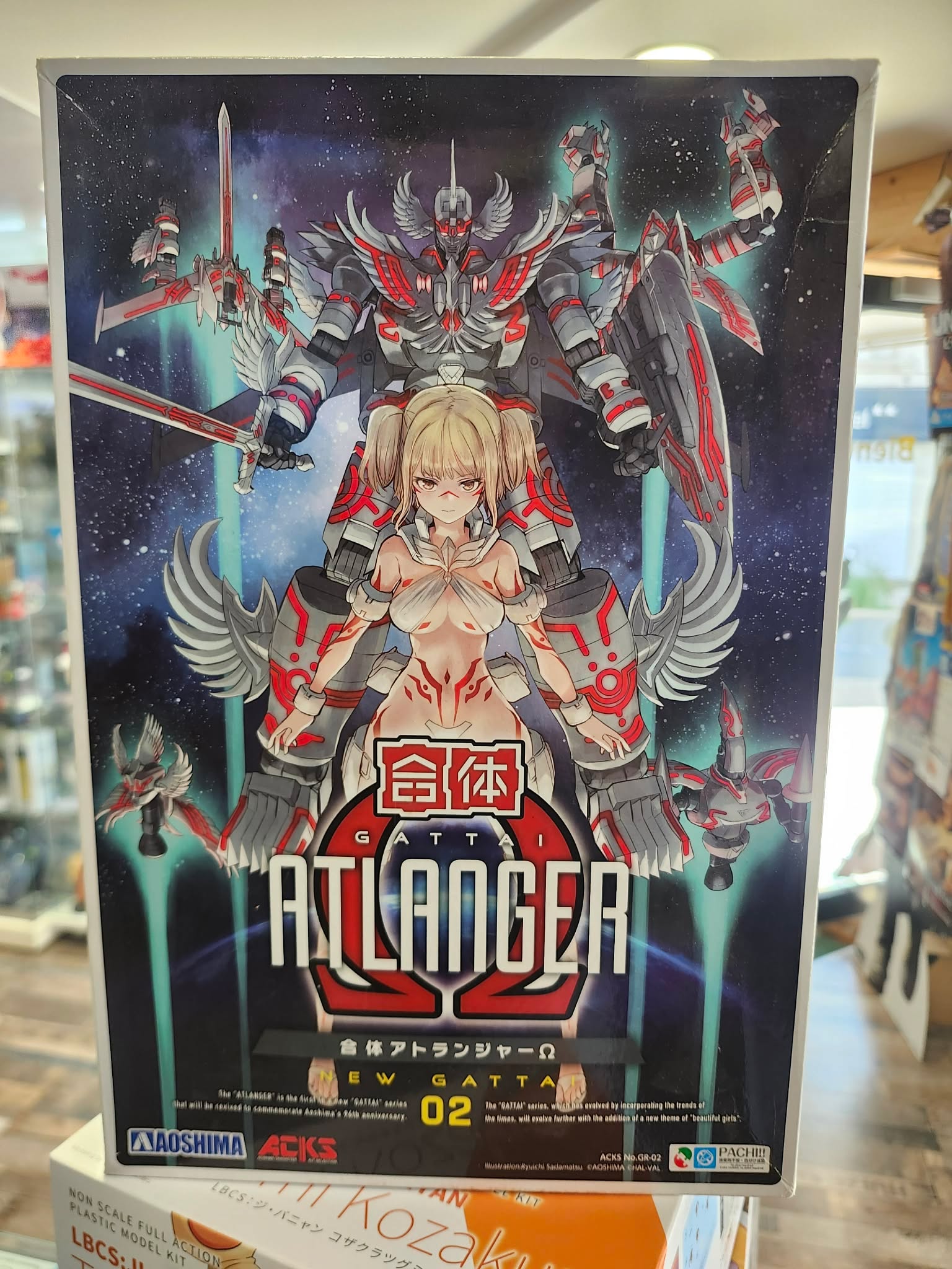 Photographie de la boîte de maquette Aoshima représentant le Gattai Atlanger, un modèle mecha japonais au design rétro et emblématique.