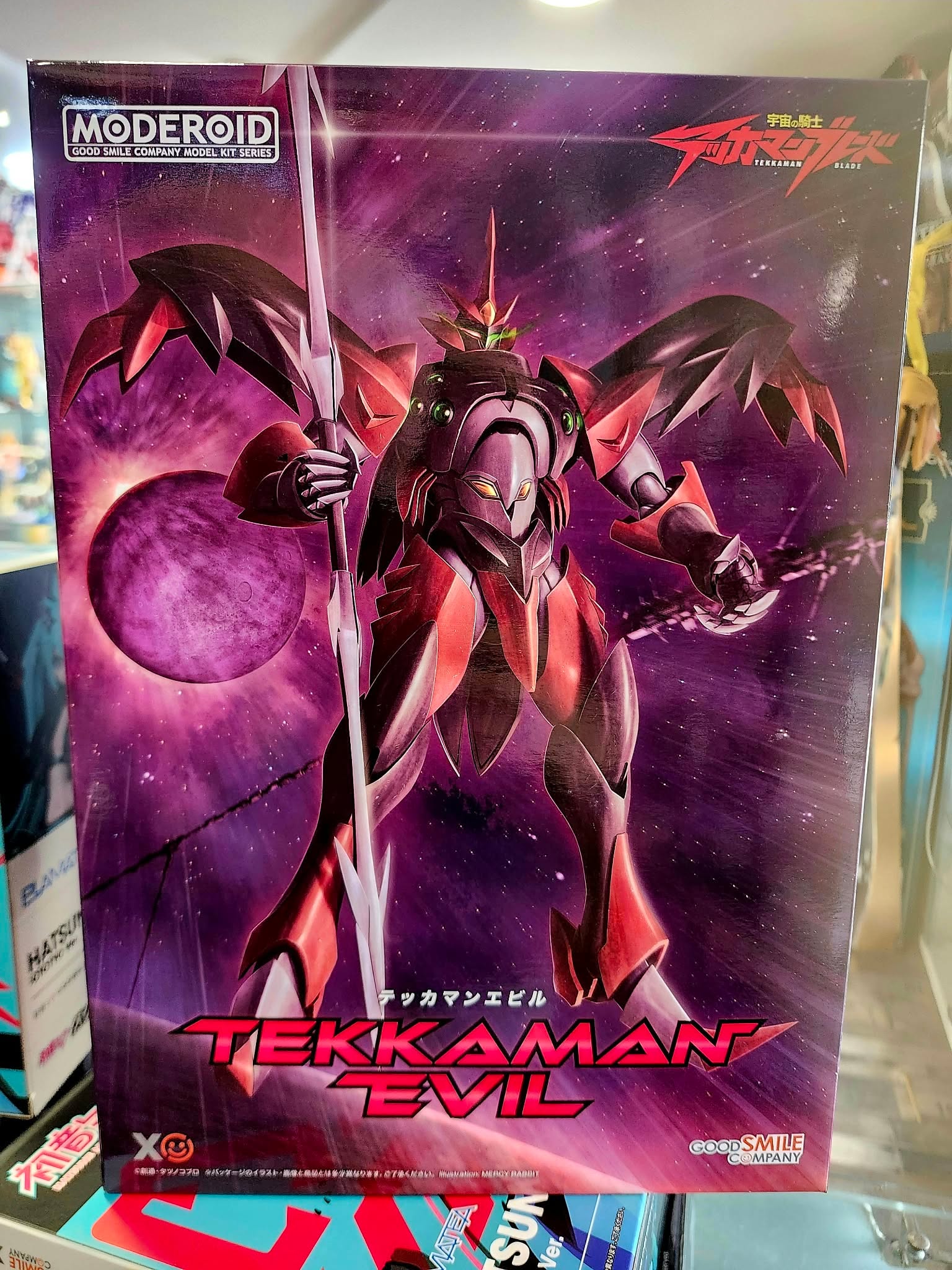 Photographie de la boîte de maquette représentant le MG Gundam Tekkaman Evil, un modèle inspiré de Tekkaman Evil dans l'univers Tekkaman Blade, au design sombre et futuriste.